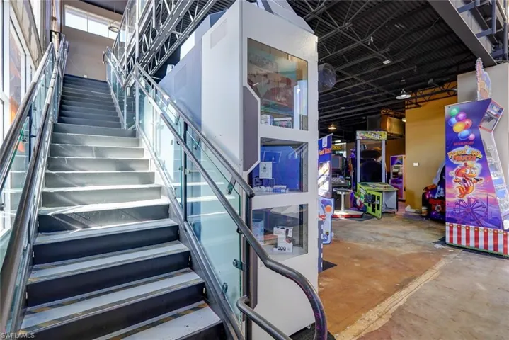Staircase featuring concrete flooring