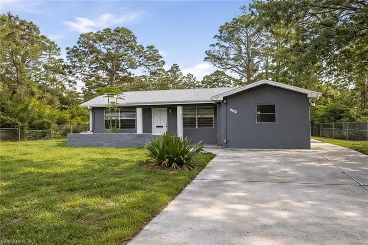 Ranch-style house featuring stucco siding and concrete driveway