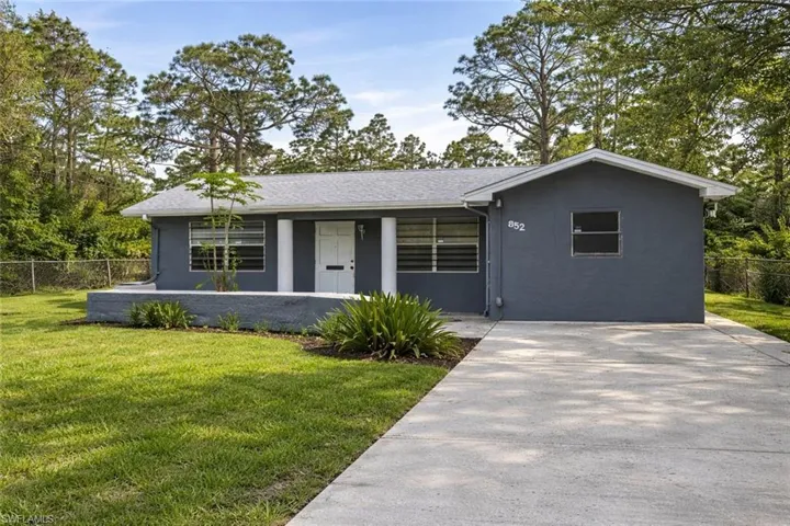 Ranch-style home with stucco siding and covered porch