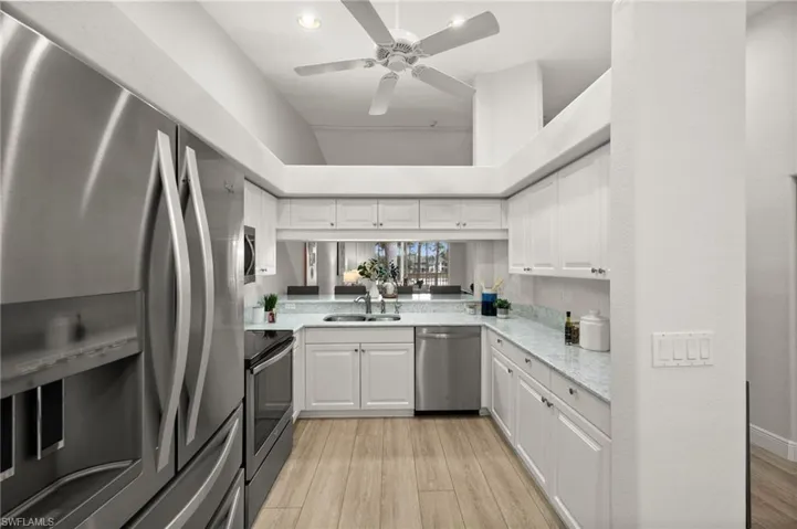 Updated kitchen with quartz countertops & stainless steel appliances.
