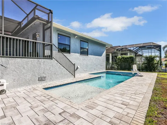 View of swimming pool featuring a lanai, a patio, and a sunroom