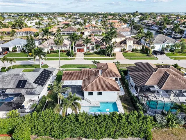 Aerial perspective of suburban area featuring a pool