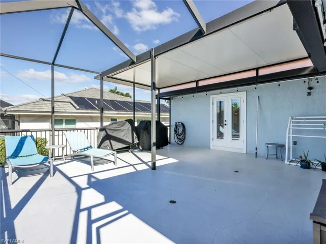 View of patio / terrace with french doors, a lanai, a sunroom, and a grill
