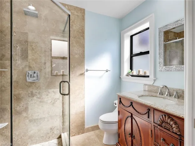 Bathroom with vanity and a stall shower