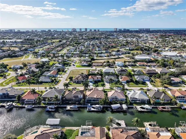 Aerial perspective of suburban area featuring a large body of water