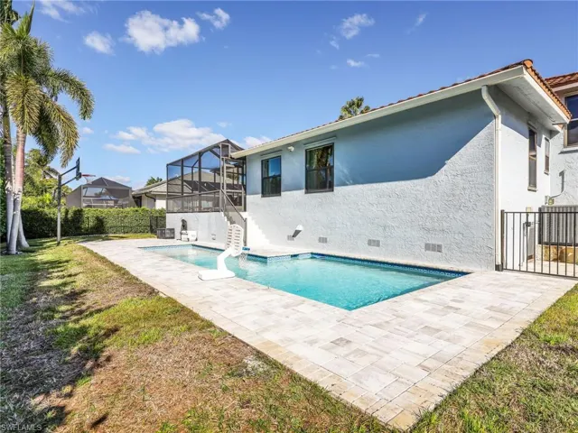 Back of property with crawl space, a patio area, stucco siding, and a sunroom