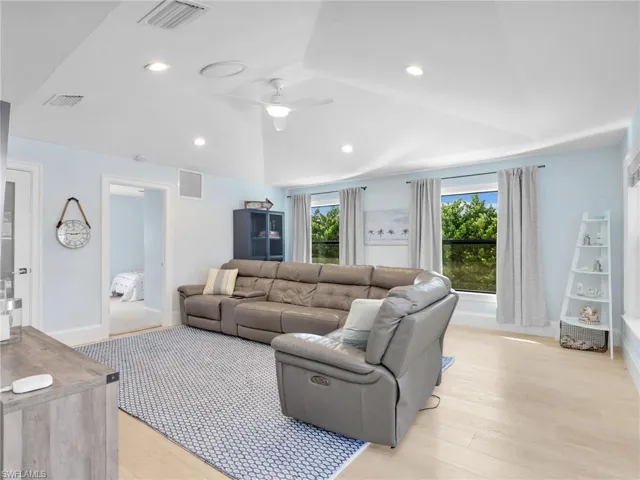 Living area featuring light wood-style floors, recessed lighting, and a ceiling fan