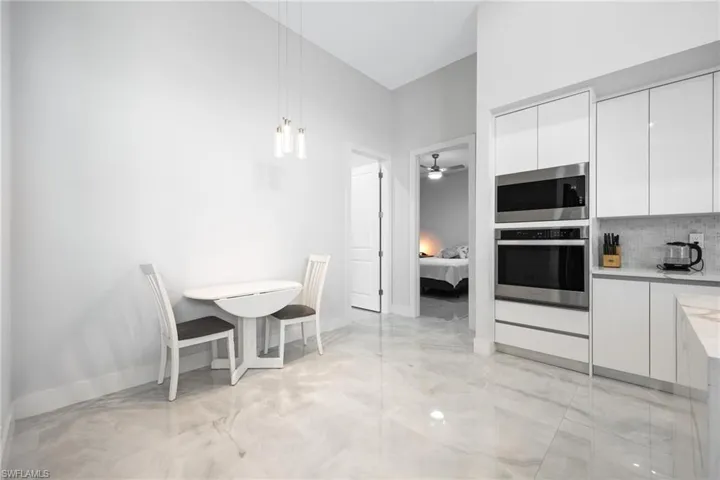 Dining area featuring baseboards and light marble finish flooring
