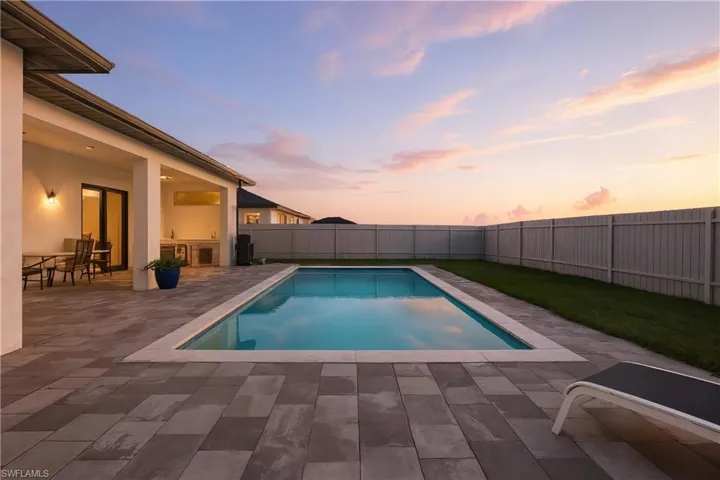 View of pool featuring a fenced backyard and a patio area
