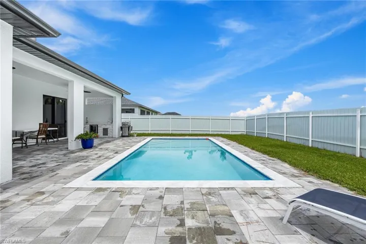 View of pool with a patio area and a fenced backyard