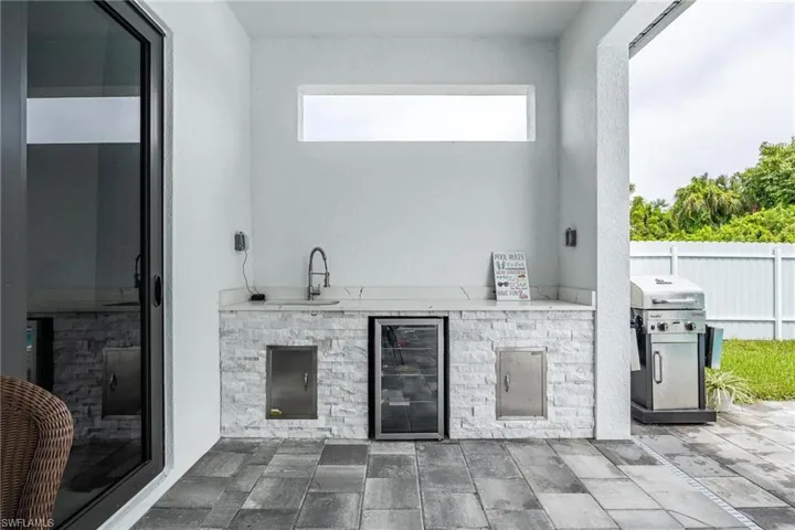 View of patio / terrace featuring exterior kitchen and wine cooler