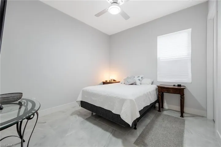 Bedroom with a ceiling fan and baseboards