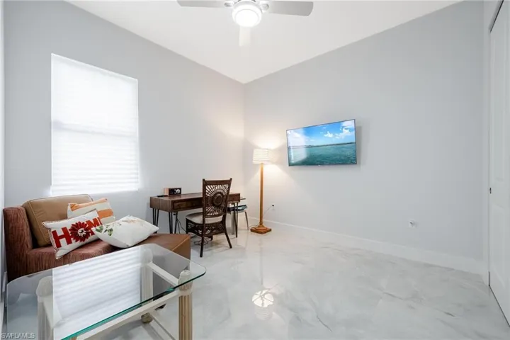 Office space with baseboards and ceiling fan