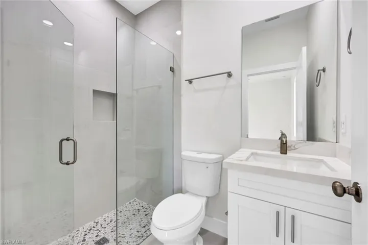 Full bath with vanity and a stall shower