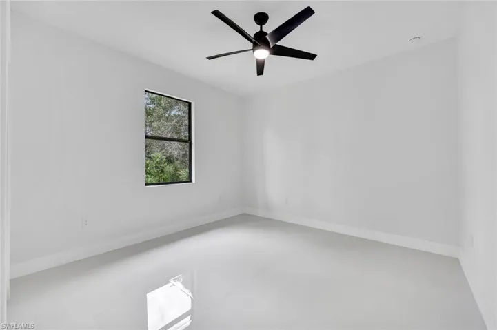Spare room featuring baseboards and ceiling fan