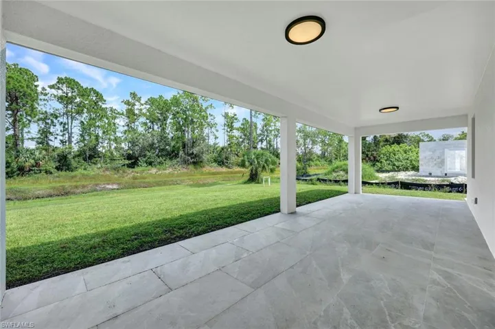 View of patio featuring view of wooded area
