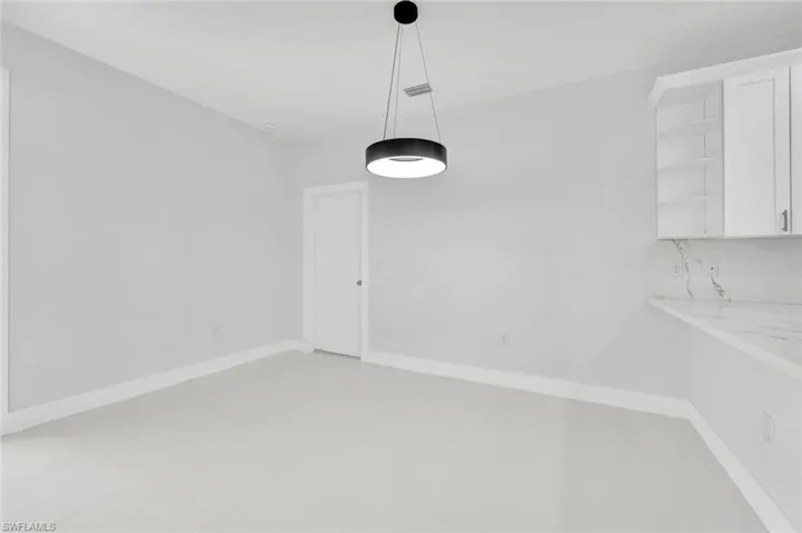 Unfurnished dining area featuring baseboards and light tile patterned floors