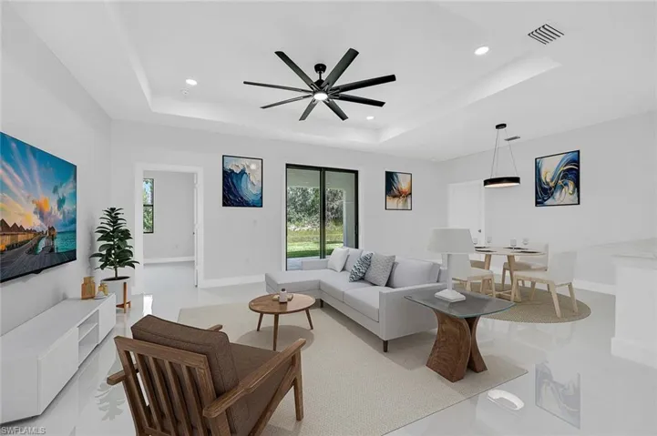 Living room featuring a ceiling fan and recessed lighting