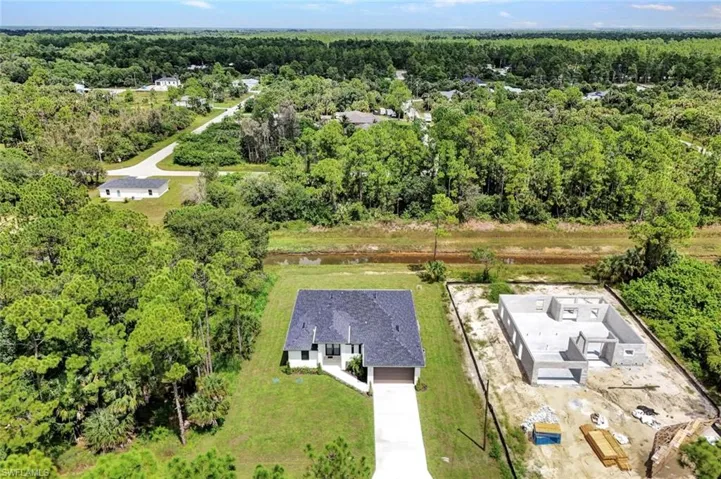 View from above of property with a heavily wooded area