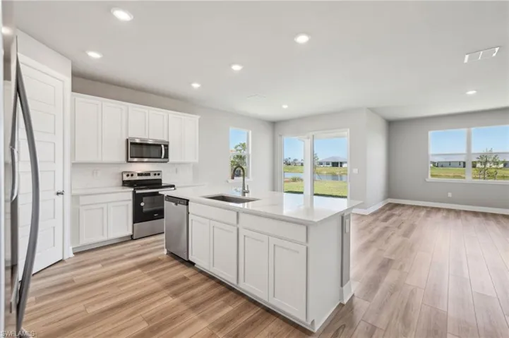 Kitchen featuring a sink, appliances with stainless steel finishes, plenty of natural light, light wood-style flooring, and recessed lighting