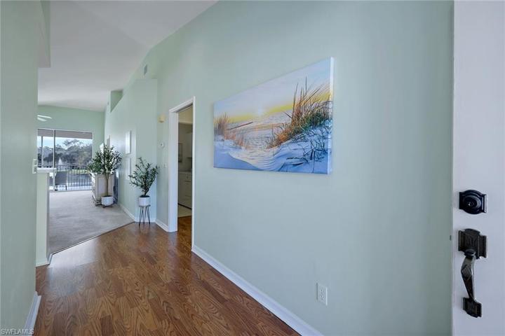 Generous foyer with wood flooring leads to great room