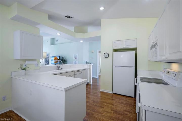 Two attached islands in kitchen, between dining and living areas