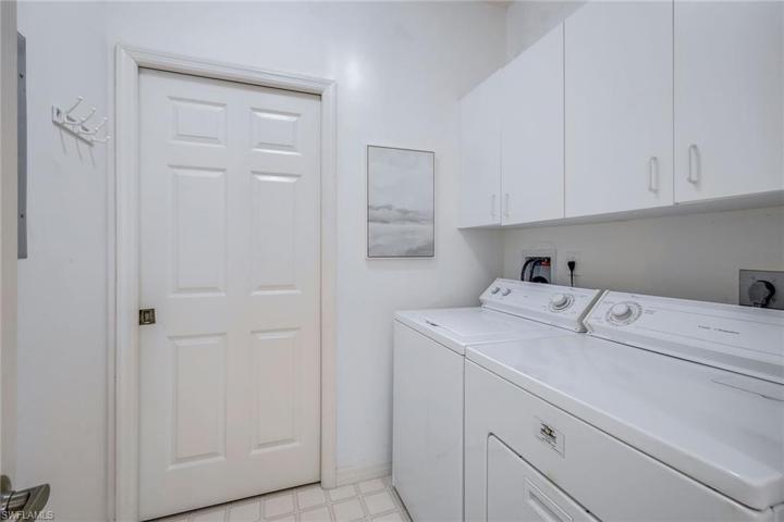 In House Laundry with cabinets and a new A/C behind the door