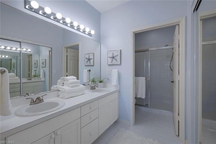 Primary Bath offers double sinks, new faucets, a shower and a walk in closetPrimary bath with double sinks and walk in closet