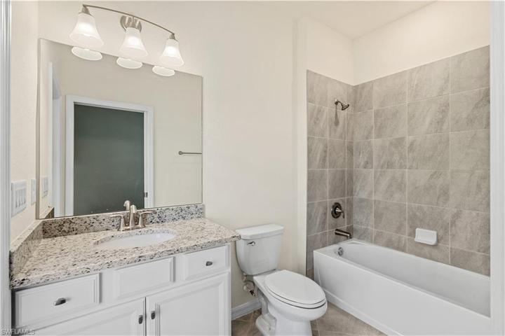 Pool bath with tub connecting to bedroom #5 as well as the lanai w/pool