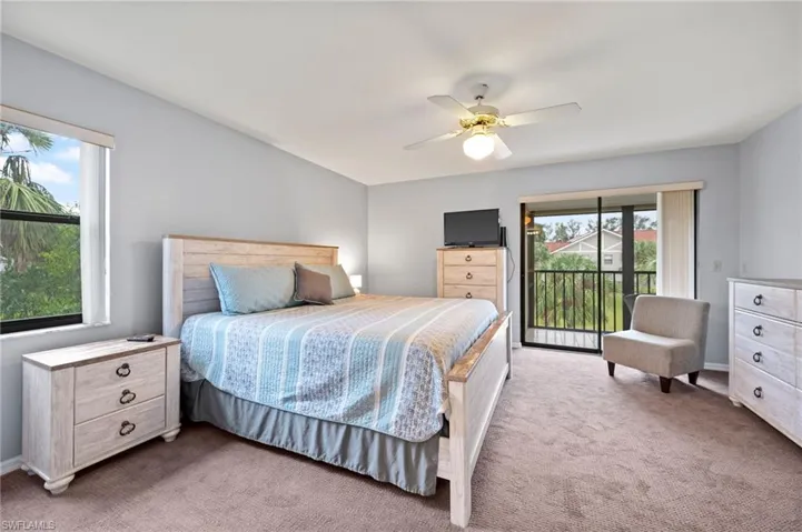 Bedroom with access to outside, light carpet, and ceiling fan