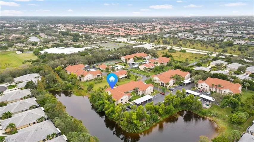 Aerial view of property's location featuring a large body of water and nearby suburban area