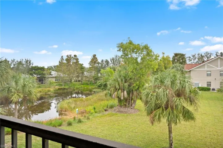 View of grassy yard with a water view