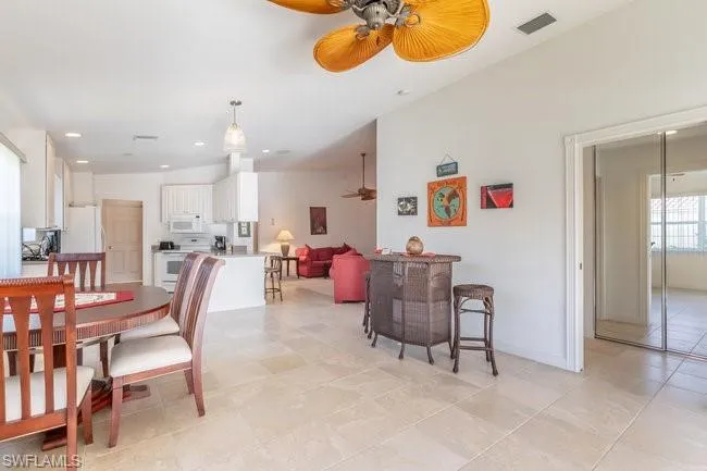 Tiled dining area featuring ceiling fan