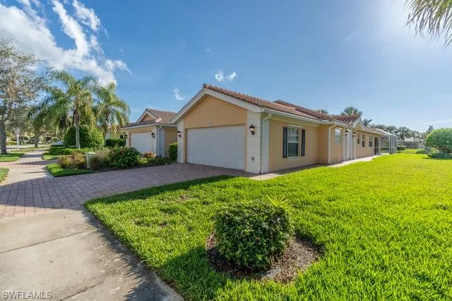 View of front of property with a garage and a front yard