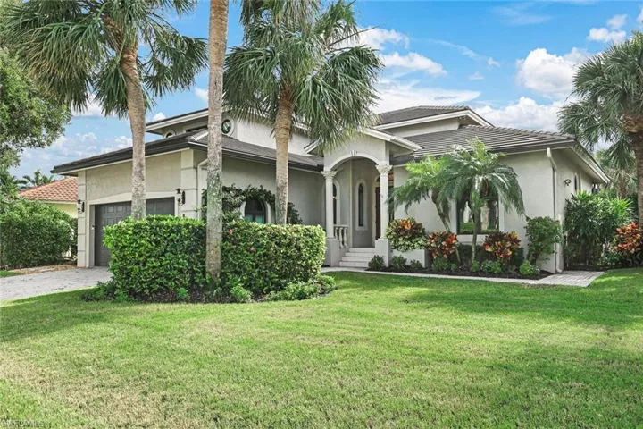 View of front facade with a front yard and a garage