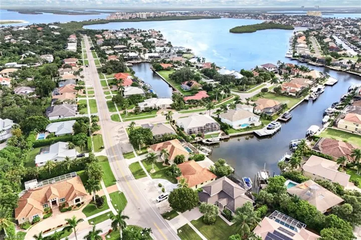 Birds eye view of property with a water view