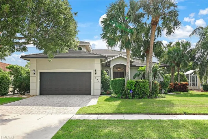 View of front of home with a front yard and a garage