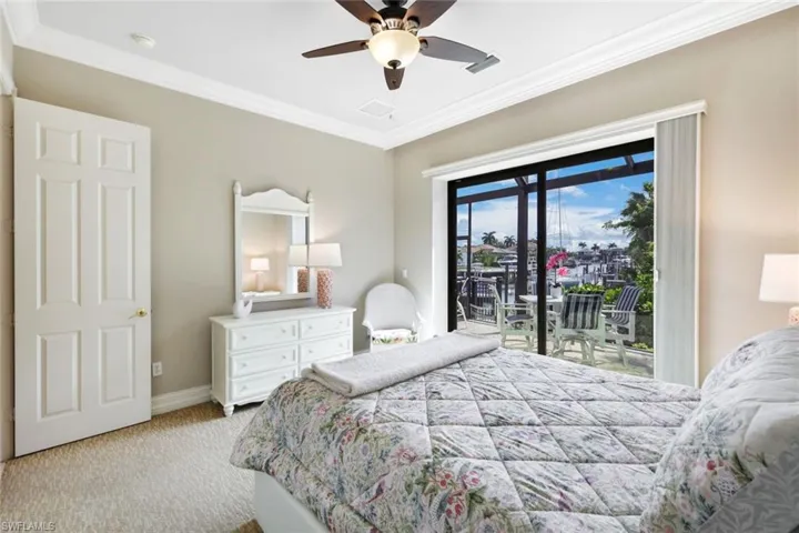 Bedroom featuring access to outside, crown molding, ceiling fan, and light carpet