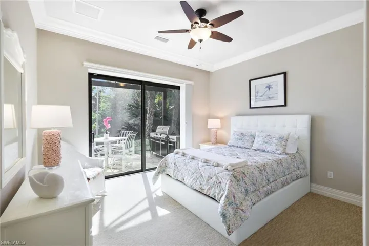 Bedroom with ceiling fan, access to outside, crown molding, and light colored carpet