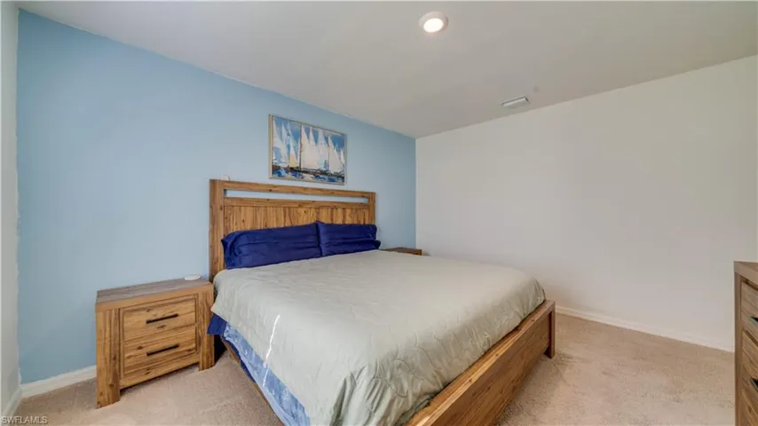 Living area with light tile patterned floors, ceiling fan, and recessed lighting