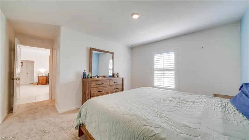 Living area with light tile patterned floors and a ceiling fan