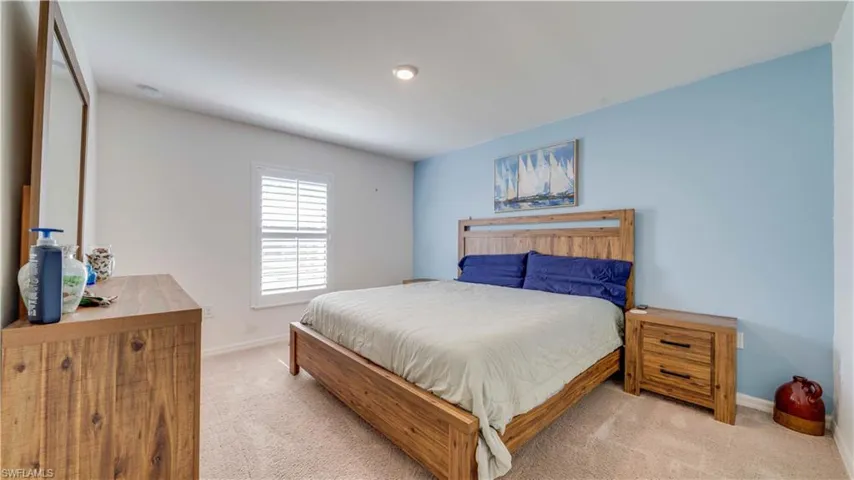 Living room featuring light tile patterned floors and ceiling fan