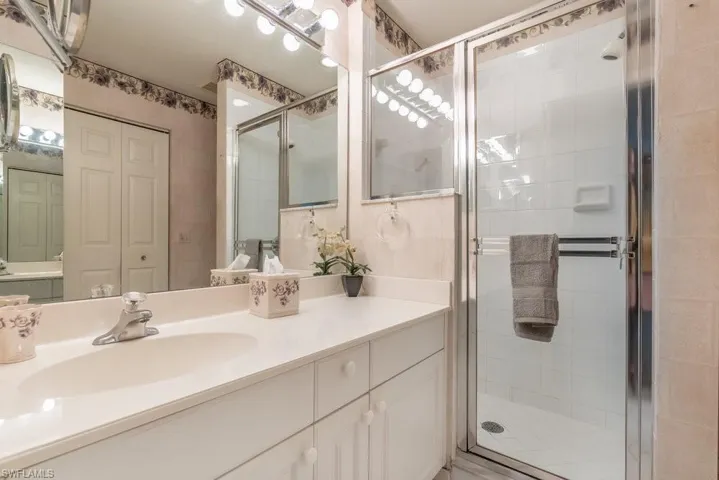 Bathroom featuring vanity and a shower with shower door