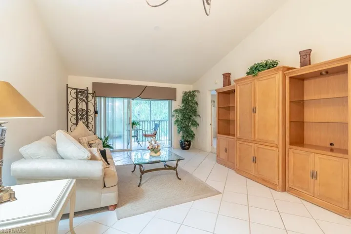 Tiled living room with high vaulted ceiling
