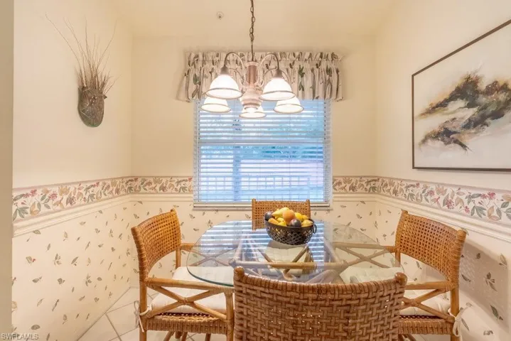 Dining room featuring tile patterned flooring and an inviting chandelier