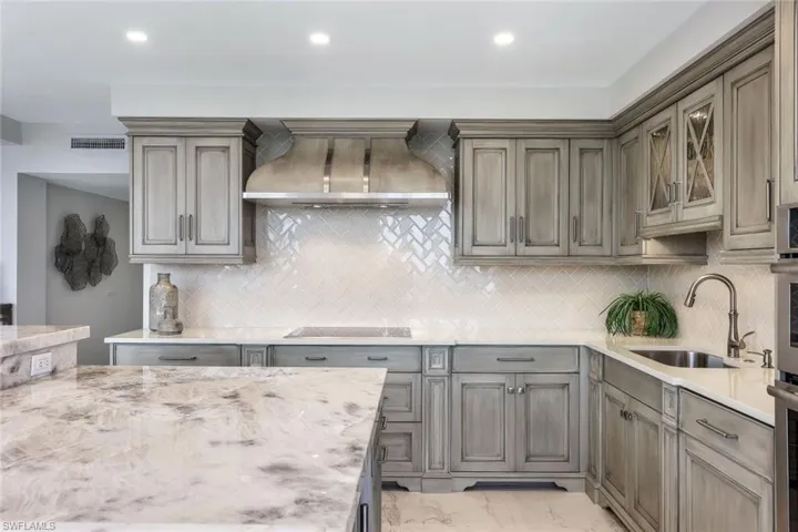 Beautiful Quartzite countertops on the large center island. Custom Ruffino cabinetry