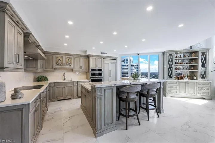 Beautiful custom kitchen and built in bar area envelops the view