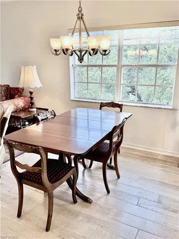 Dining room featuring light wood finished floors and a chandelier