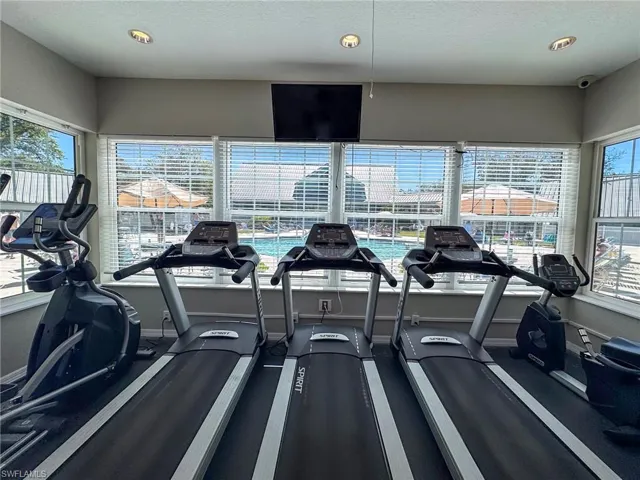 Workout area with a textured ceiling and recessed lighting