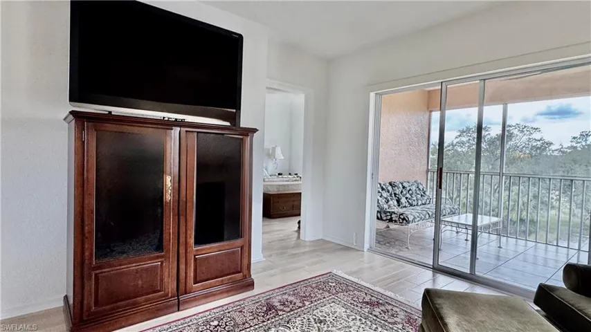 Living area featuring light wood-style flooring and baseboards